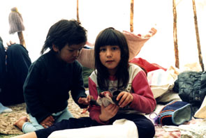 Soni and Tommy pluck a partridge for supper at Kamashkushkatinau-nipi. Photo courtesy Camille Fouillard.