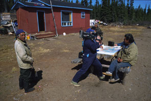 CBC TV interviews Etuat Andrew in front of his cabin at Shatshit, Mishen Jack looks on. Photo courtesy Peter Armitage.