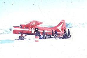 Unloading supplies and gear at Utshimassit. Uniam Katshinak on snowmobile. Photo courtesy Innu Nation.